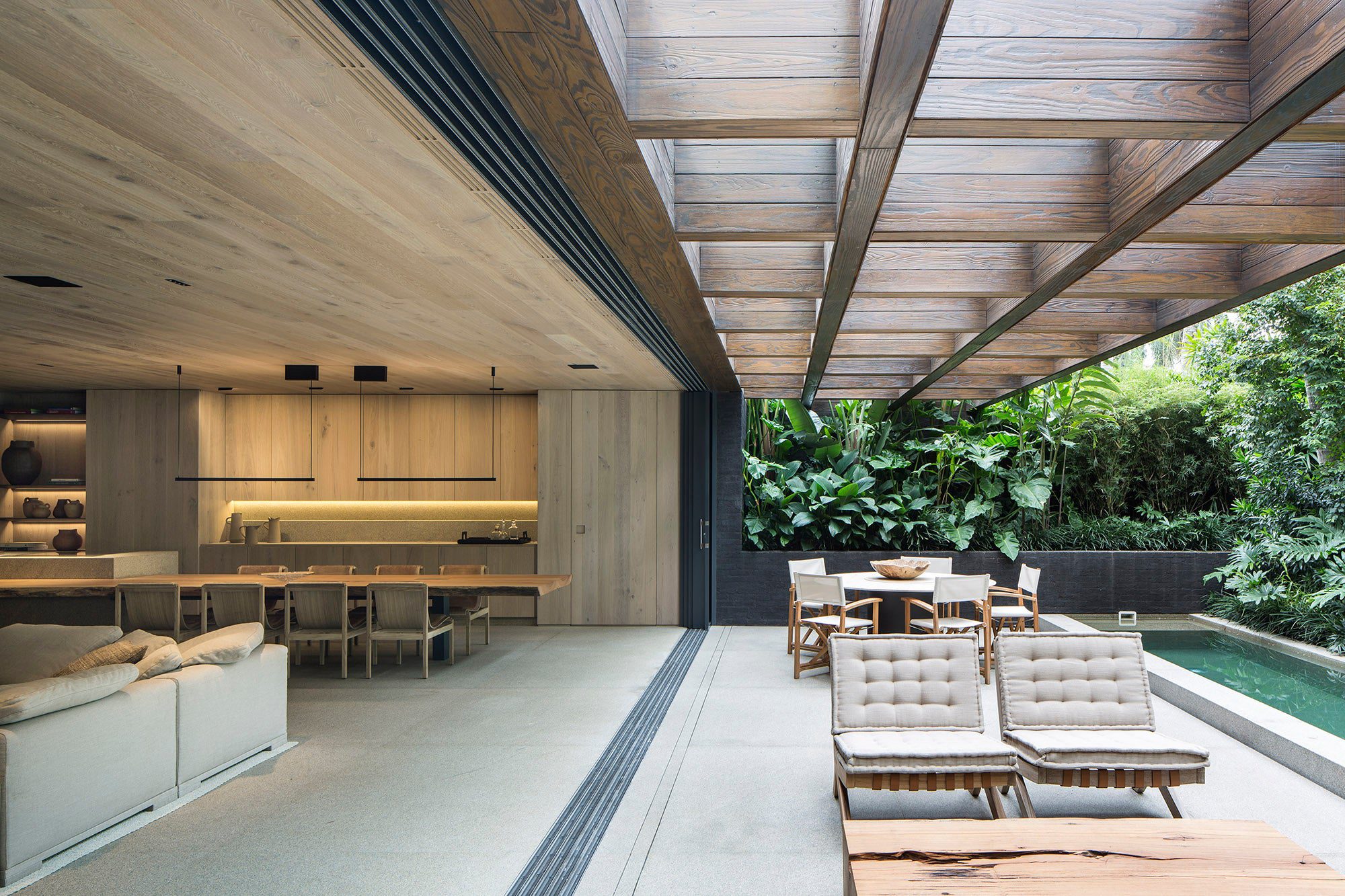 O teto vazado na parte externa do living proporciona luz natural e uma valorização ainda maior do amplo espaço desse ambiente